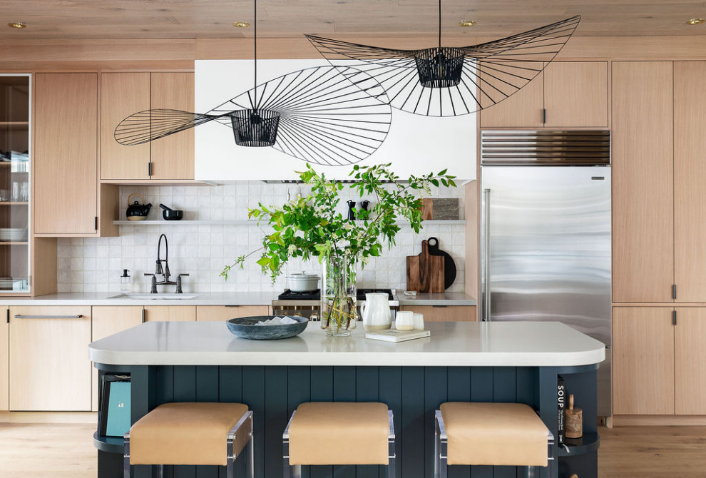 This is an example of a mid-sized modern eat-in kitchen in Toronto with an undermount sink, flat-panel cabinets, light wood cabinets, quartz benchtops, white splashback, stone tile splashback, stainless steel appliances, light hardwood floors, with island, beige floor, grey benchtop and wood.