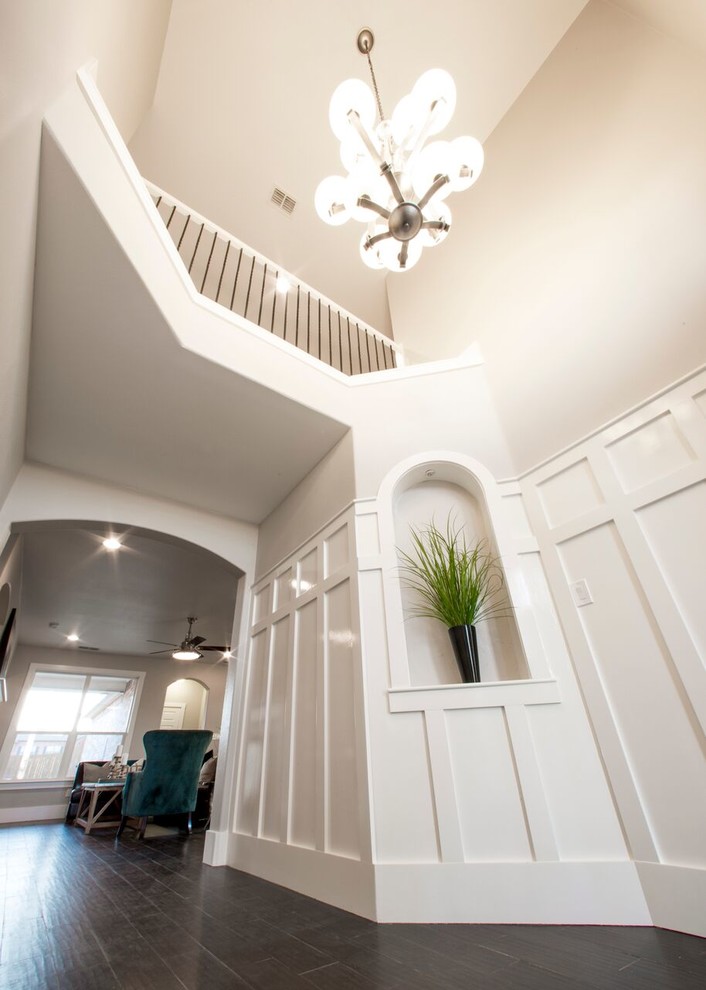 Example of a transitional porcelain tile home design design in Austin with gray walls and a black front door
