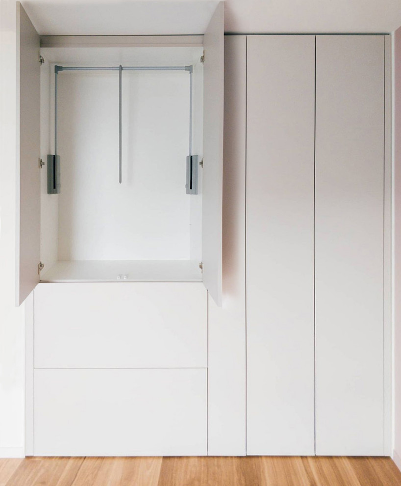 Diseño de armario y vestidor escandinavo de tamaño medio con armarios con rebordes decorativos y puertas de armario beige