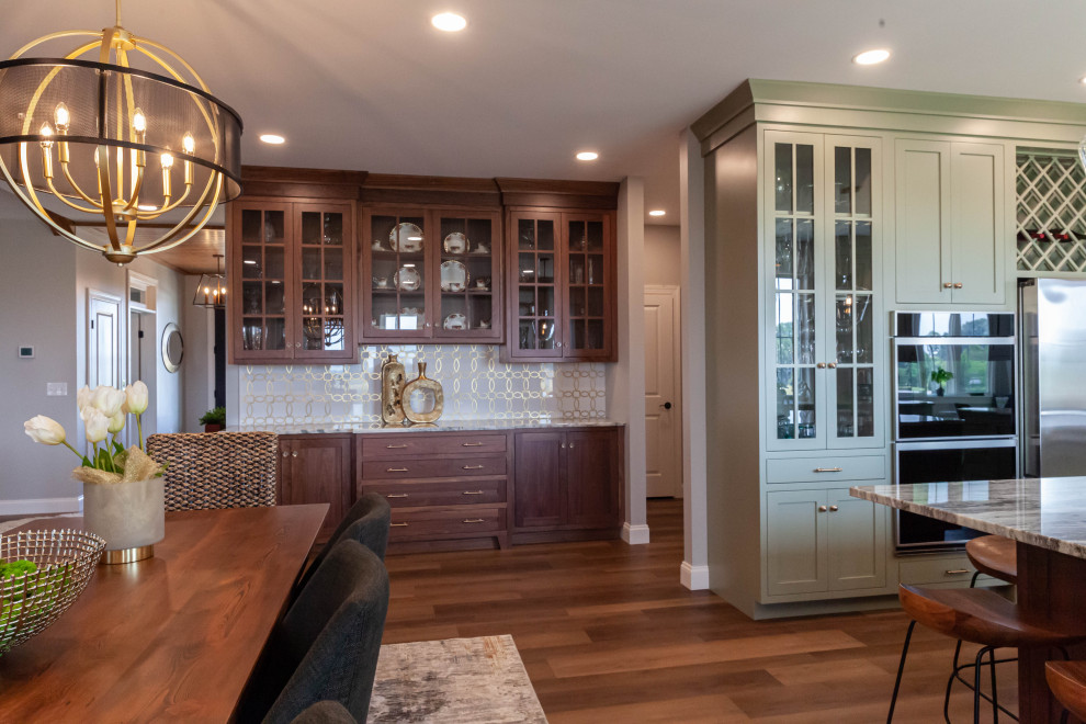Inspiration for a large transitional u-shaped vinyl floor and brown floor open concept kitchen remodel with a farmhouse sink, beaded inset cabinets, green cabinets, granite countertops, white backsplash, subway tile backsplash, stainless steel appliances, an island and beige countertops