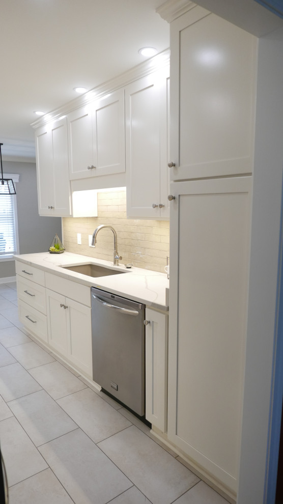 Eat-in kitchen - mid-sized transitional galley porcelain tile and beige floor eat-in kitchen idea with an undermount sink, shaker cabinets, white cabinets, quartz countertops, brown backsplash, porcelain backsplash, stainless steel appliances, no island and white countertops