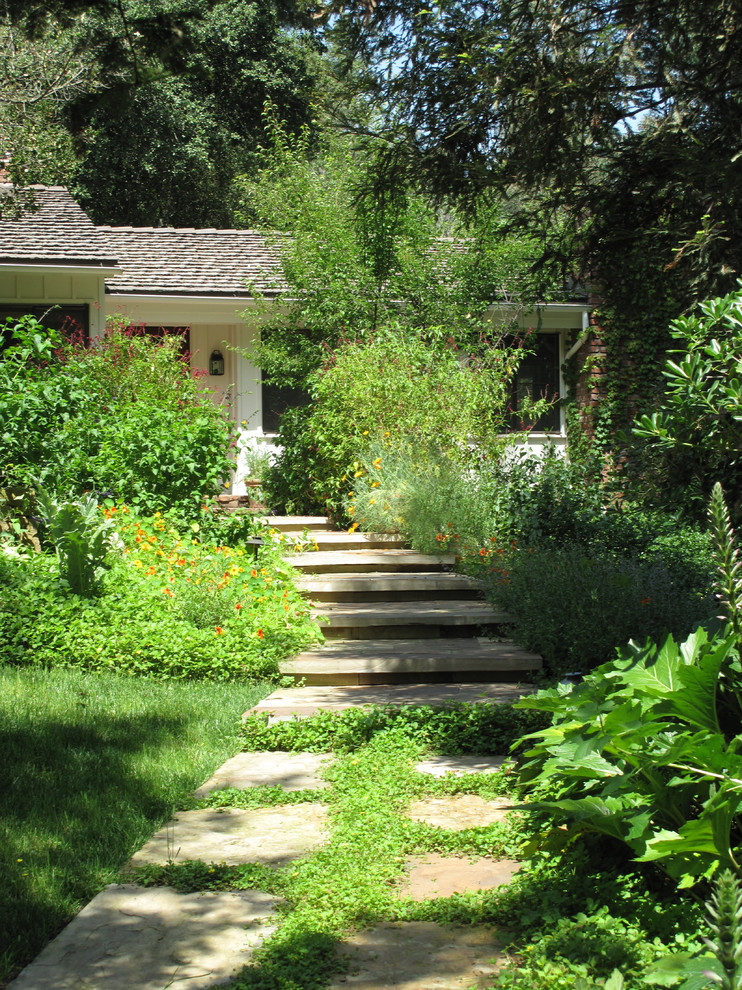 Photo of a traditional backyard partial sun garden in Los Angeles with a garden path and natural stone pavers.