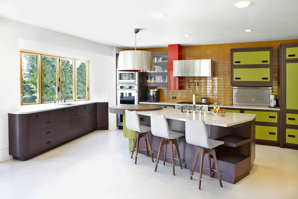 Eclectic kitchen in San Francisco with stainless steel appliances and green cabinets.