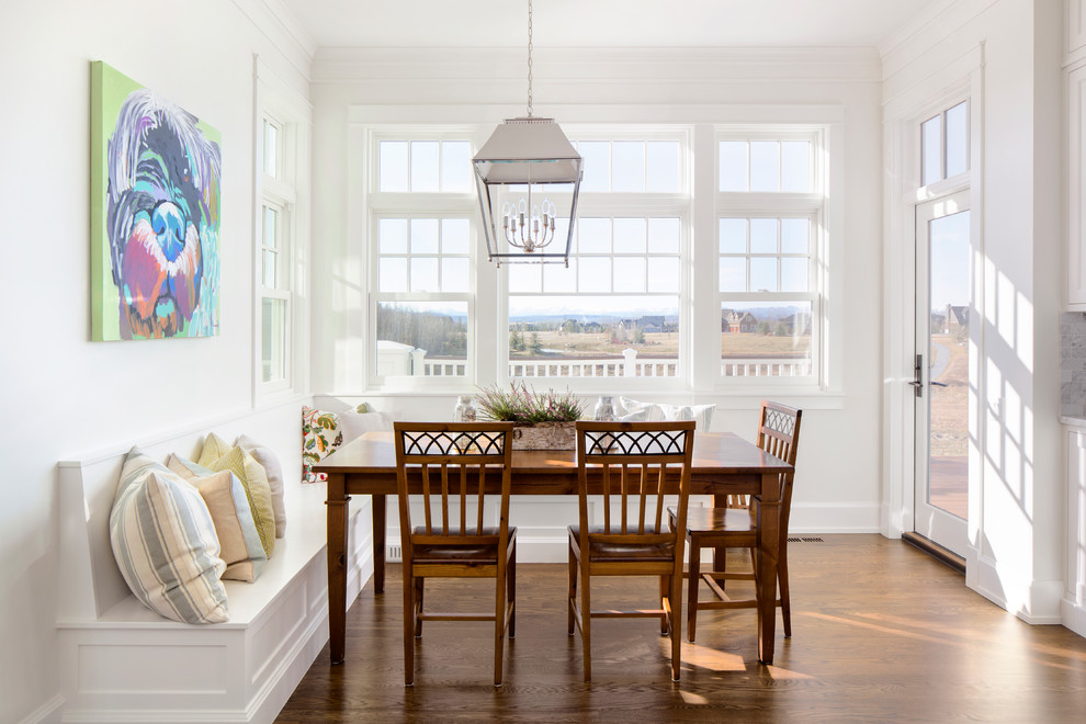 Inspiration for a traditional dining room in Calgary with white walls, medium hardwood floors and brown floor.