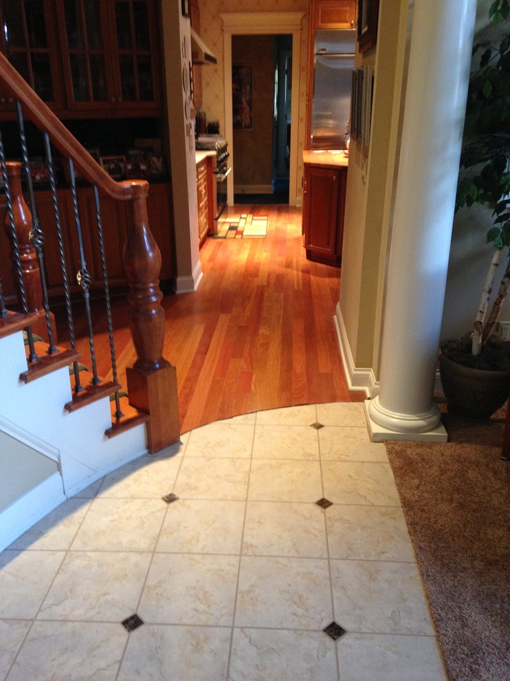Mid-sized traditional hallway in Cleveland with beige walls and ceramic floors.