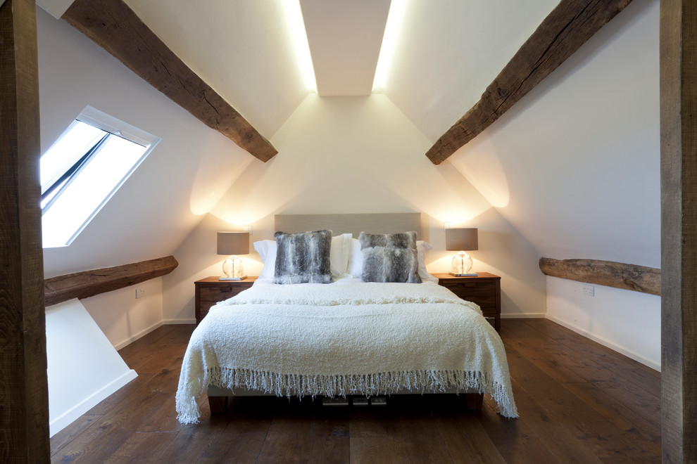 Inspiration for a contemporary bedroom in London with white walls, dark hardwood floors and no fireplace.