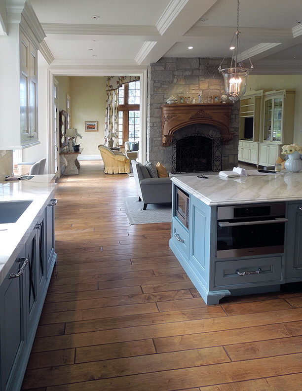 Inspiration for a large victorian l-shaped medium tone wood floor, brown floor and coffered ceiling eat-in kitchen remodel in Chicago with an undermount sink, raised-panel cabinets, gray cabinets, granite countertops, stainless steel appliances, an island and white countertops