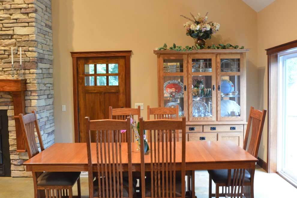 Dining room - mid-sized contemporary dining room idea with beige walls, a standard fireplace and a stone fireplace