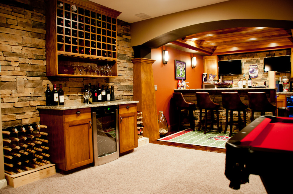 This is an example of a large traditional wine cellar in Minneapolis with carpet, display racks and beige floor.