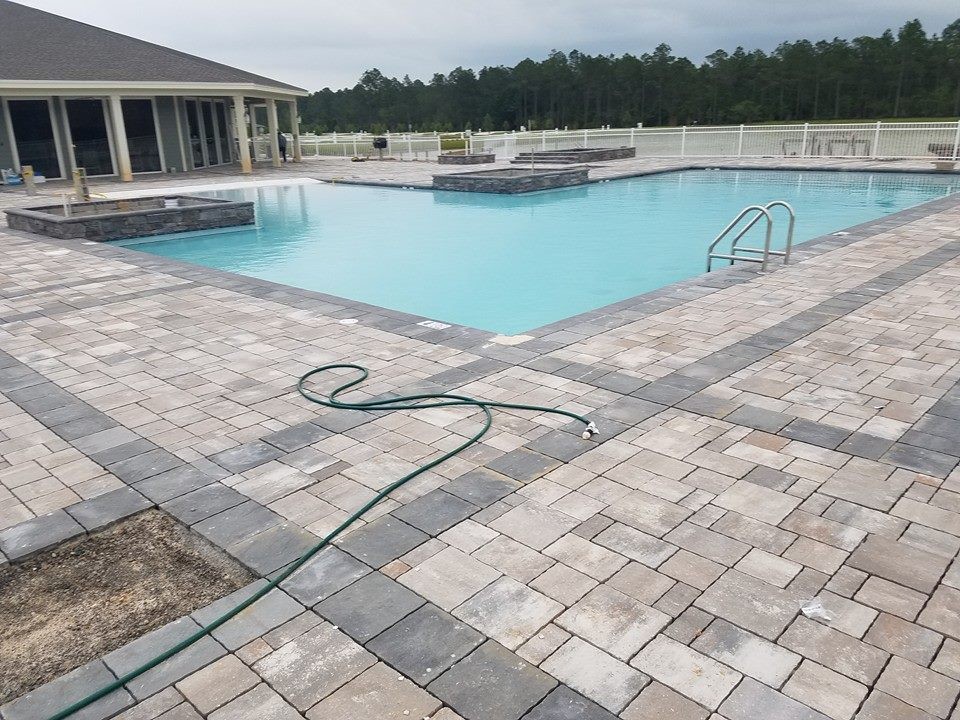 Large transitional backyard stone and custom-shaped natural hot tub photo in Miami