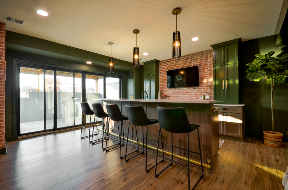 Imagen de sótano con puerta moderno grande con bar en casa, paredes verdes, suelo vinílico, vigas vistas y ladrillo