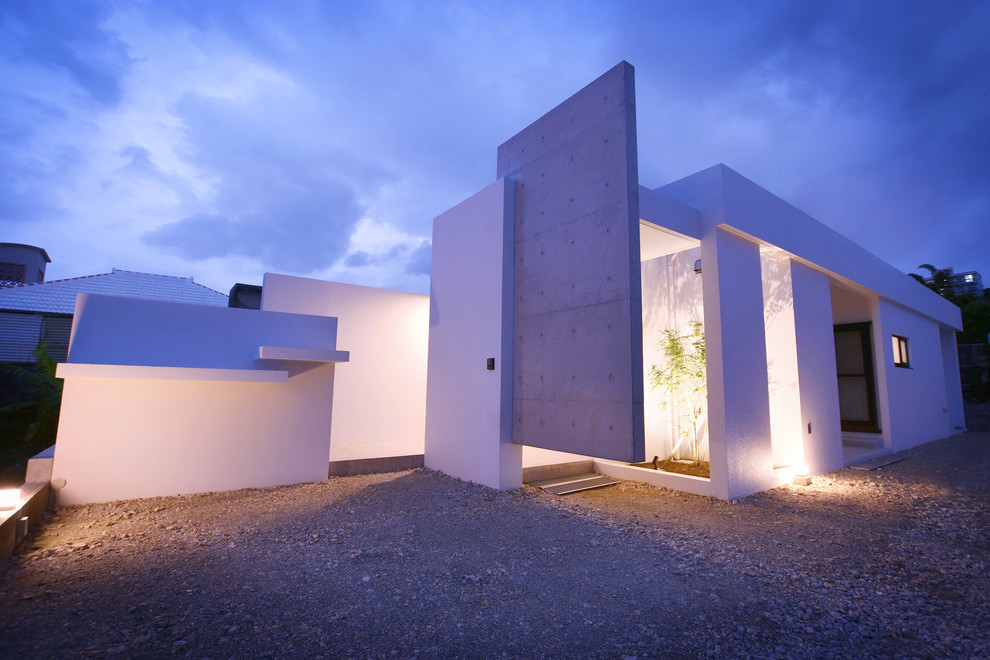 This is an example of a modern one-storey concrete grey house exterior in Other with a flat roof.