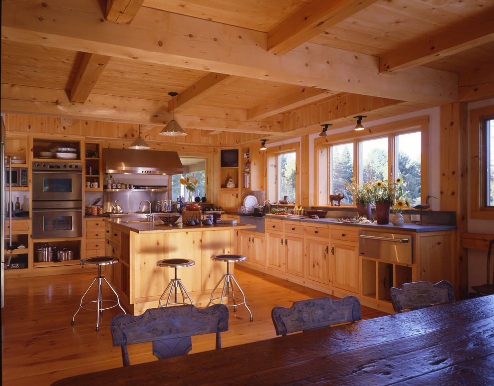 Inspiration for a country u-shaped eat-in kitchen in Boston with a drop-in sink, recessed-panel cabinets, light wood cabinets, stainless steel appliances, medium hardwood floors and with island.