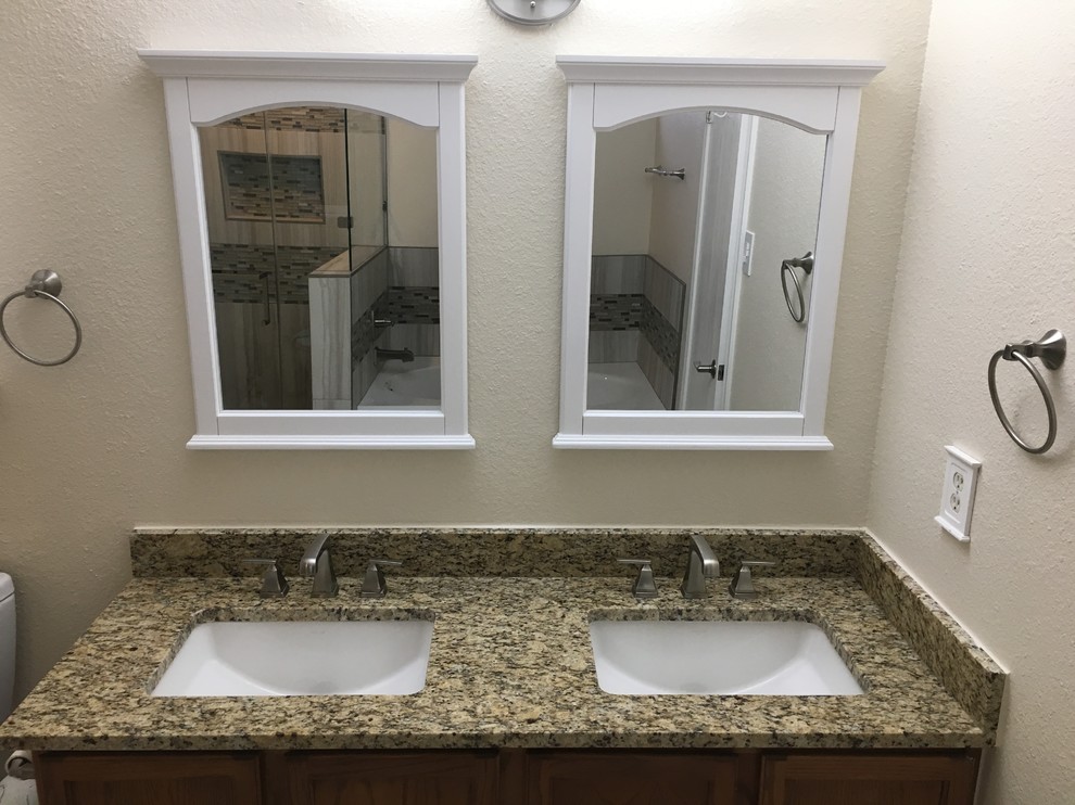 Design ideas for a mid-sized transitional master bathroom in Austin with an alcove tub, beige walls, an undermount sink, granite benchtops and multi-coloured benchtops.