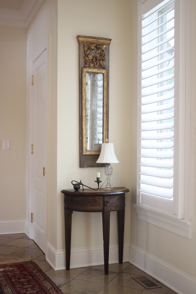 This is an example of a mid-sized eclectic foyer in Raleigh with beige walls, ceramic floors and a single front door.