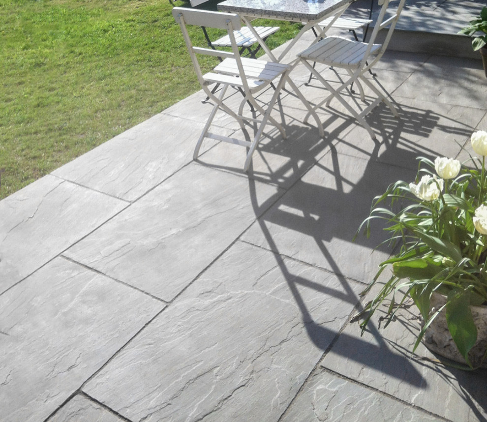 Inspiration for a medium sized classic back patio in Hertfordshire with natural stone paving.