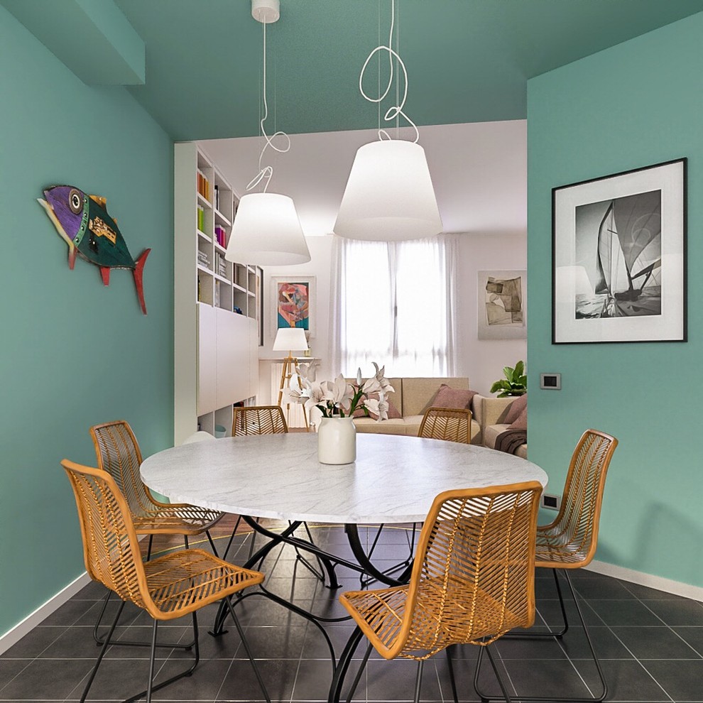Mid-sized beach style dining room in Milan with green walls, ceramic floors and black floor.