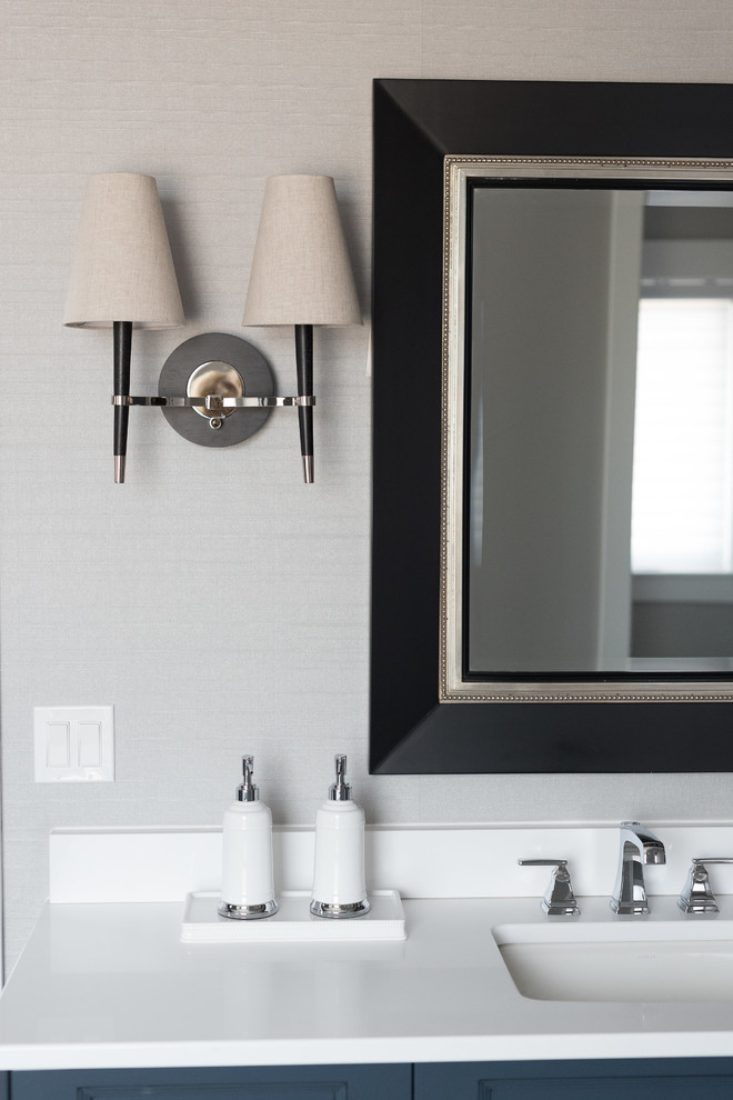 Large transitional master gray tile and subway tile porcelain tile and white floor freestanding bathtub photo in Denver with recessed-panel cabinets, blue cabinets, gray walls, an undermount sink and solid surface countertops