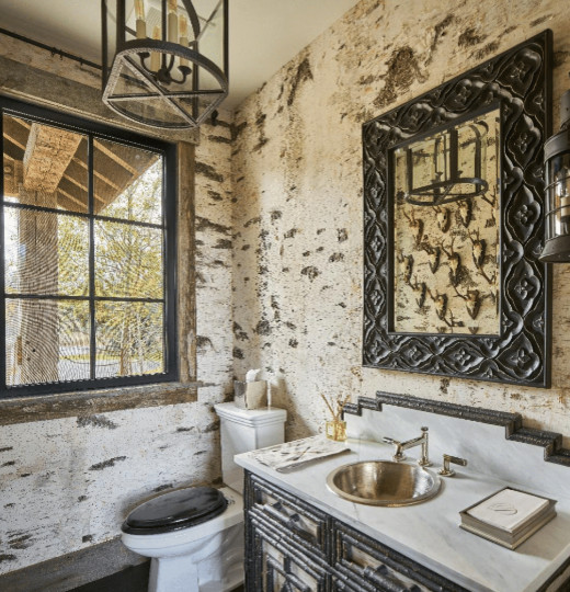 This is an example of a mid-sized country powder room in Other with furniture-like cabinets, black cabinets, a two-piece toilet, multi-coloured walls, dark hardwood floors, a drop-in sink, marble benchtops, black floor and white benchtops.