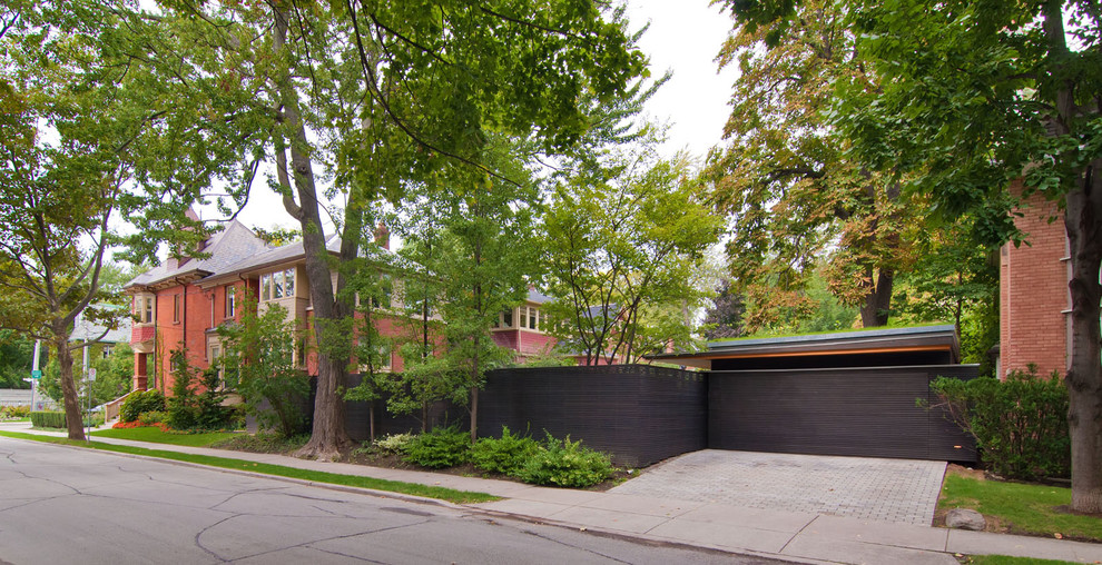 Design ideas for a large modern two-storey brick red exterior in Toronto with a hip roof.