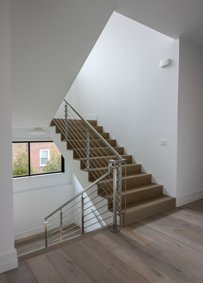 Inspiration for a mid-sized modern wood u-shaped staircase in DC Metro with wood risers and metal railing.