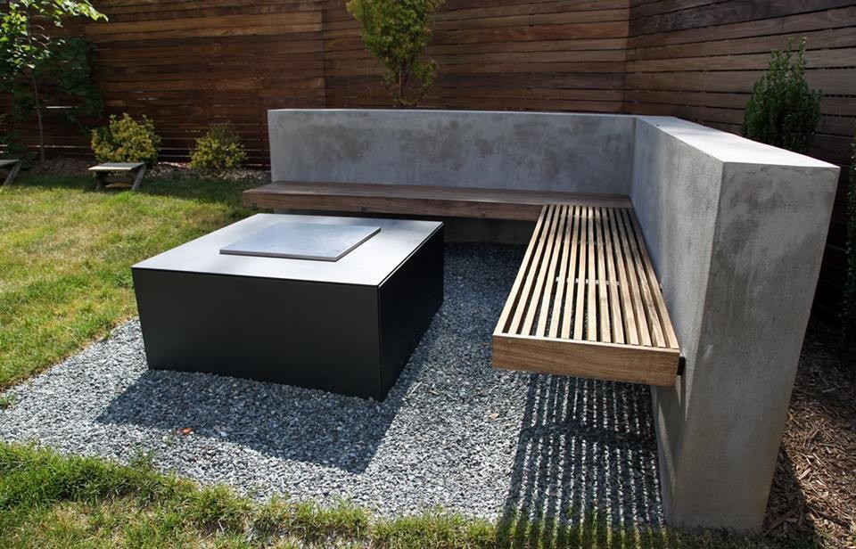 Photo of a mid-sized modern backyard partial sun garden in DC Metro with a fire feature and concrete pavers.