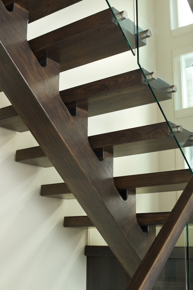 Inspiration for a modern wooden floating open and glass railing staircase remodel in Edmonton