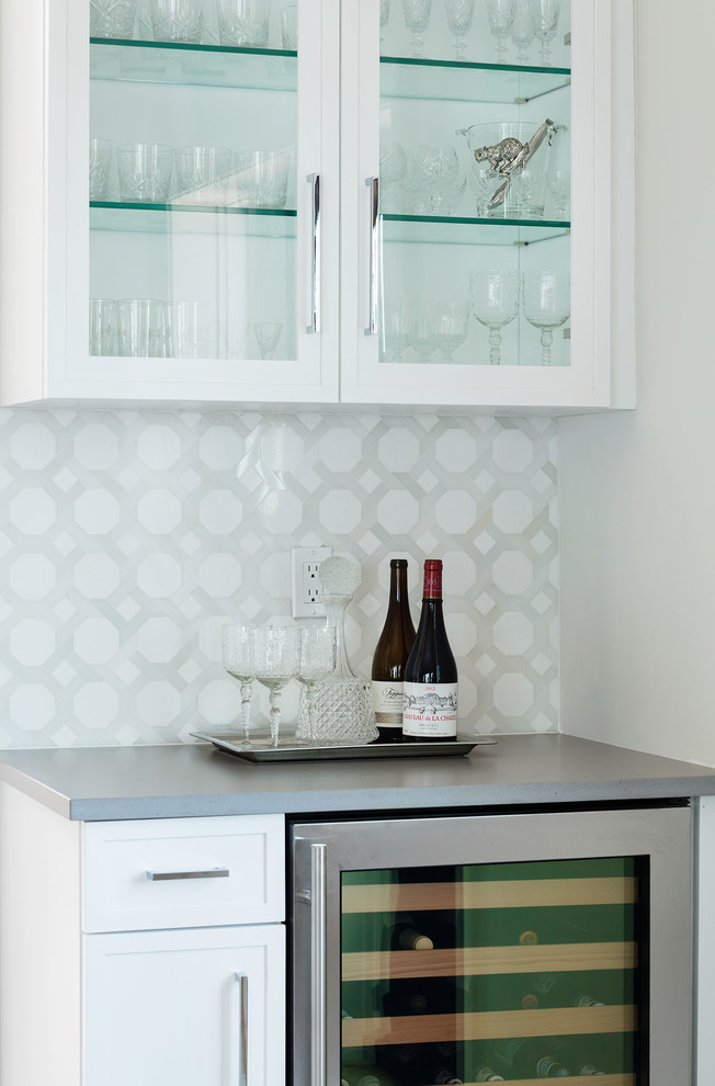 Design ideas for a small transitional single-wall home bar in New York with white cabinets, quartzite benchtops, grey splashback, mosaic tile splashback and grey benchtop.