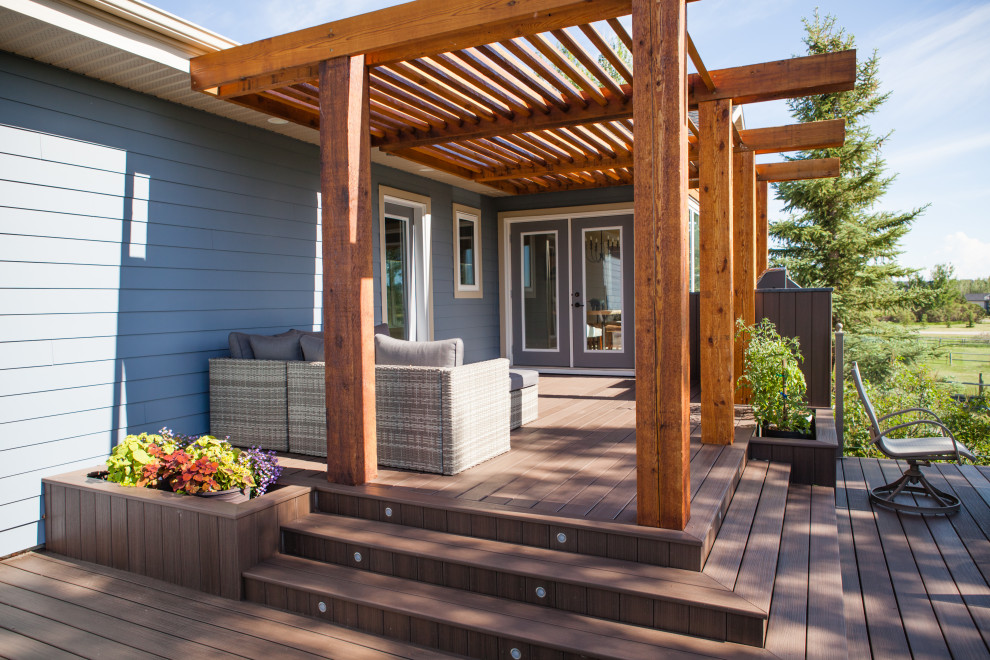 Deck - mid-sized contemporary backyard deck idea in Calgary with a pergola