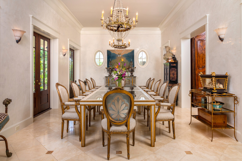 Inspiration for a mediterranean separate dining room in Miami with white walls and beige floor.