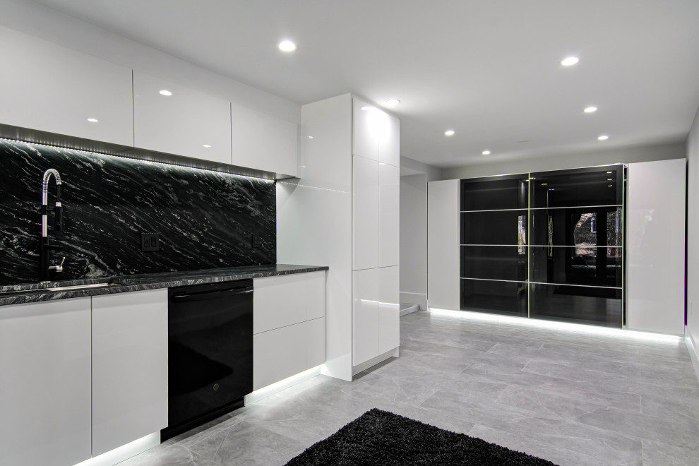 This is an example of a small modern single-wall kitchen pantry in Miami with a built-in sink, flat-panel cabinets, white cabinets, granite worktops, black splashback, granite splashback, black appliances, porcelain flooring, no island, grey floors and black worktops.