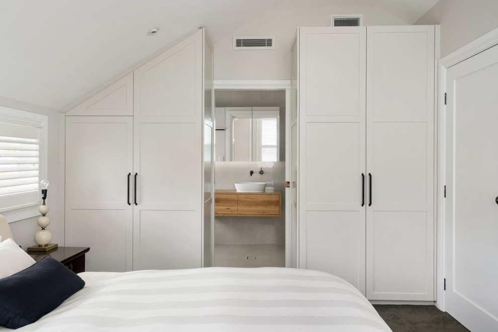 Example of a transitional bedroom design in Sydney
