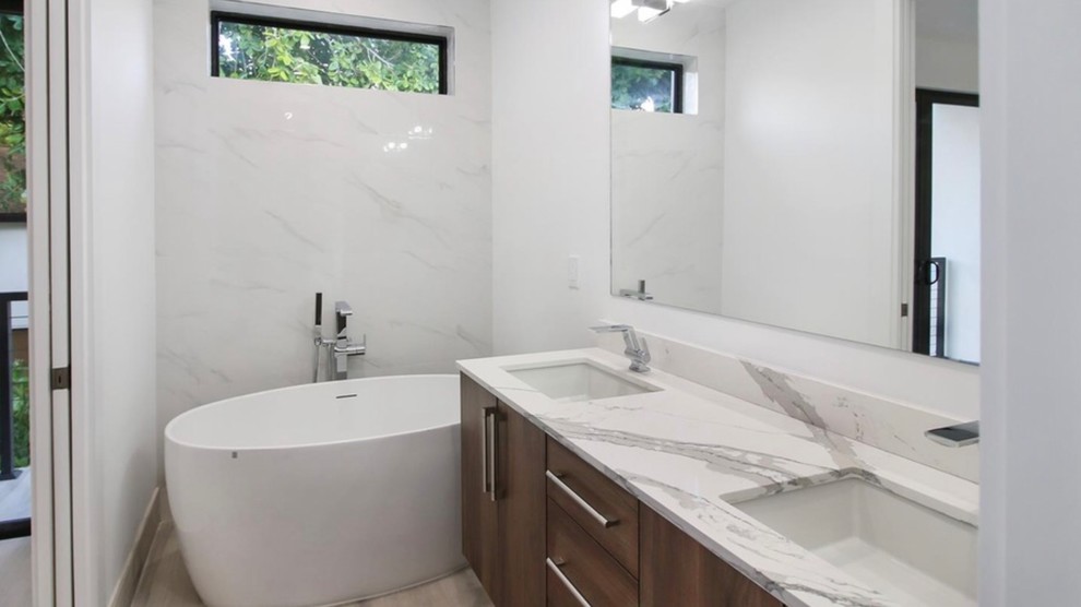 Inspiration for a small modern master bathroom in San Francisco with flat-panel cabinets, brown cabinets, a freestanding tub, white tile, ceramic tile, multi-coloured walls, laminate floors, an undermount sink, engineered quartz benchtops, multi-coloured floor and multi-coloured benchtops.
