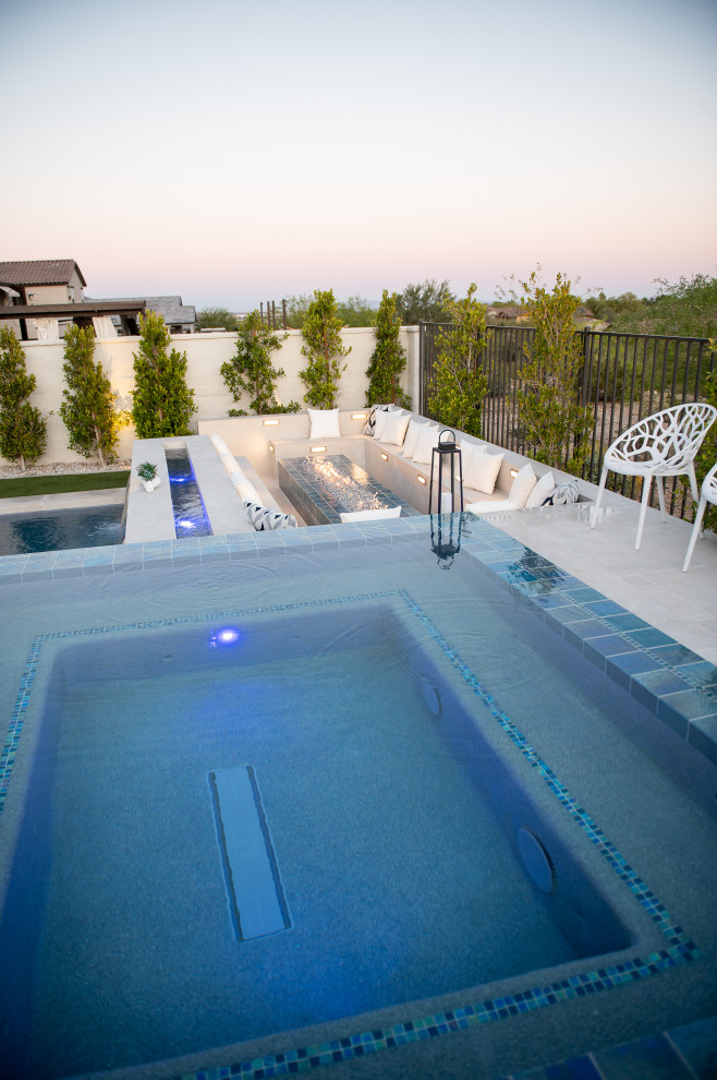 Raised, "rimflow" spa with sunken fire pit area