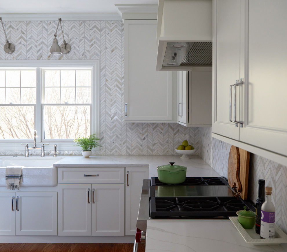 Inspiration for a large transitional l-shaped medium tone wood floor and brown floor eat-in kitchen remodel in Chicago with a farmhouse sink, shaker cabinets, white cabinets, quartz countertops, multicolored backsplash, marble backsplash, stainless steel appliances, an island and white countertops