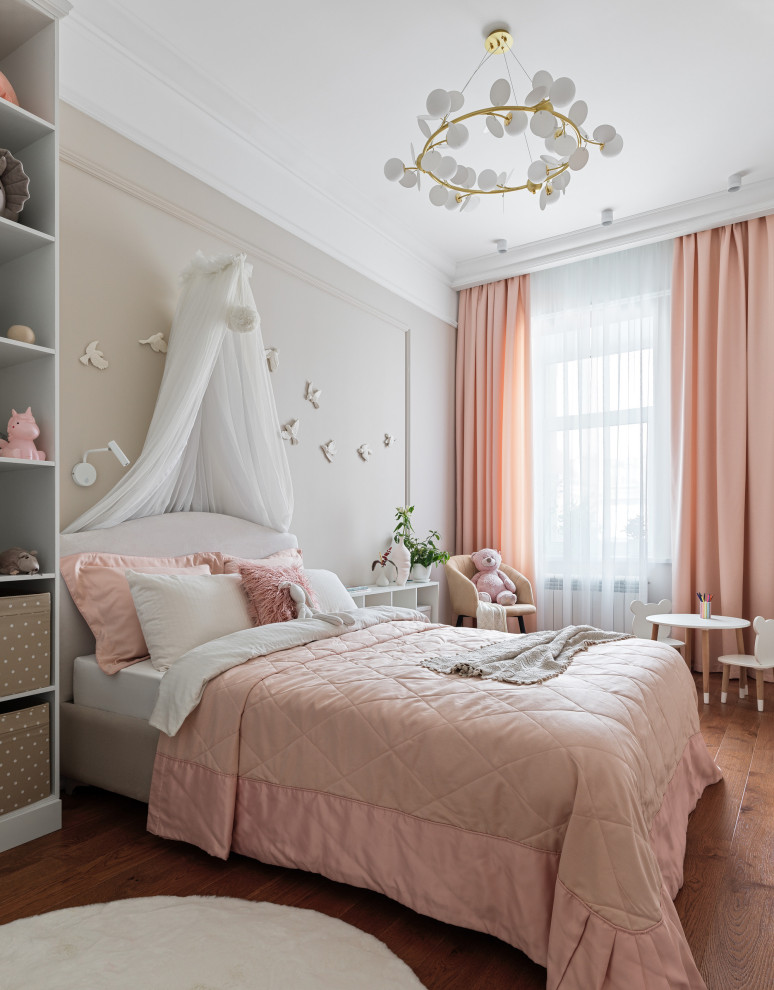 Inspiration for a mid-sized transitional kids' room for girls in Other with beige walls, medium hardwood floors and brown floor.