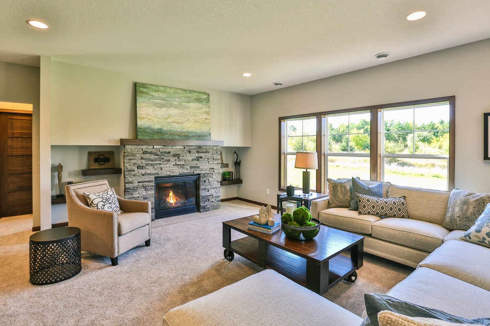 Inspiration for a mid-sized contemporary open concept family room in Minneapolis with beige walls, carpet, a standard fireplace and a stone fireplace surround.