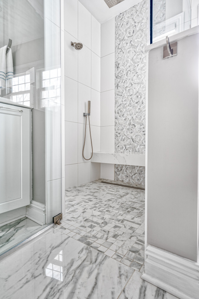 Photo of an expansive transitional master bathroom in New York with shaker cabinets, white cabinets, a freestanding tub, a curbless shower, a bidet, white tile, porcelain tile, beige walls, marble floors, an undermount sink, quartzite benchtops, a hinged shower door and white benchtops.