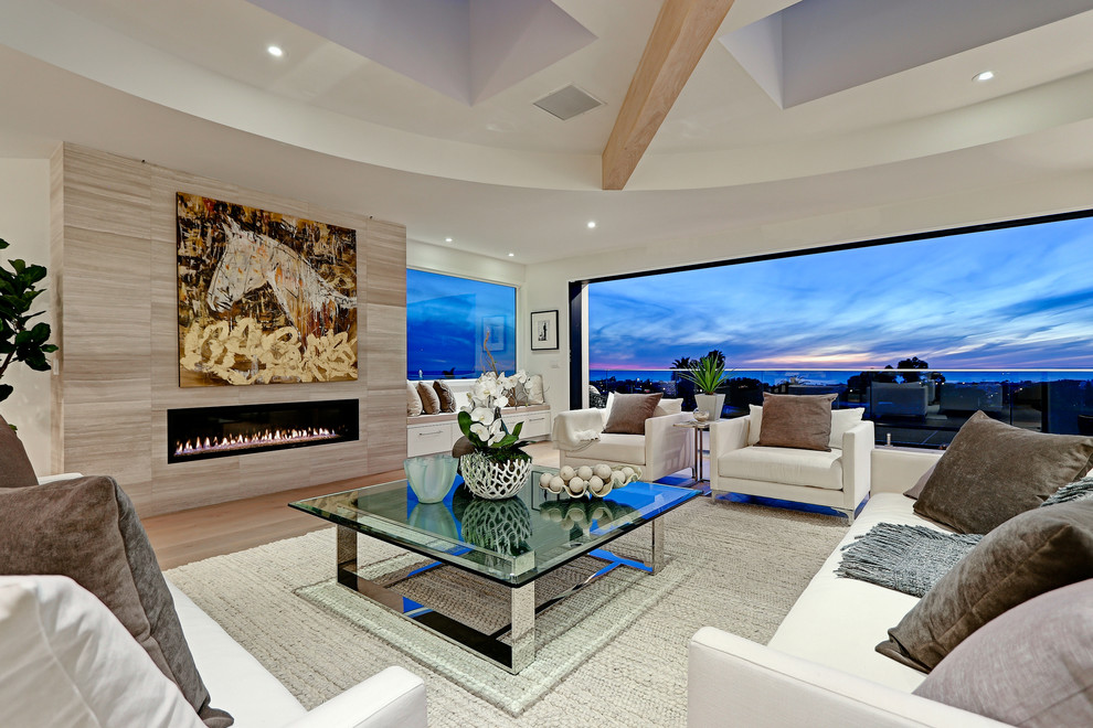 Design ideas for an expansive contemporary open concept living room in Los Angeles with white walls, a ribbon fireplace, a tile fireplace surround, a built-in media wall and light hardwood floors.