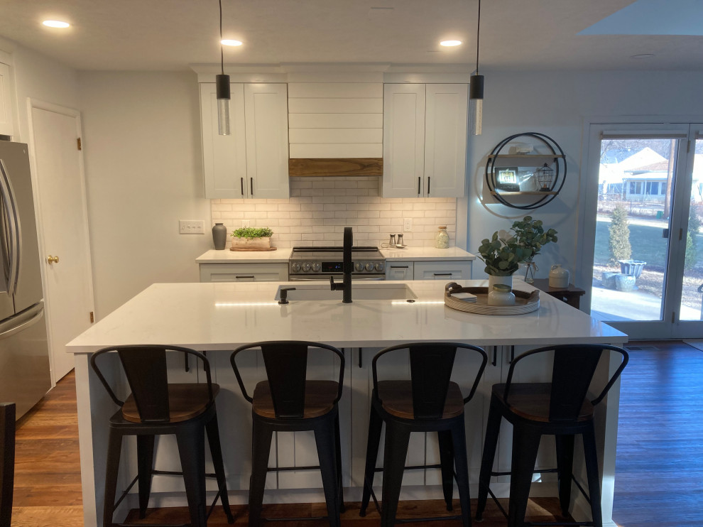 Inspiration for a large transitional eat-in kitchen in Other with shaker cabinets, white cabinets, quartz benchtops, white splashback, subway tile splashback, with island and white benchtop.