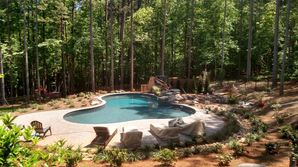 Pool fountain - large transitional backyard concrete paver and custom-shaped natural pool fountain idea in Raleigh