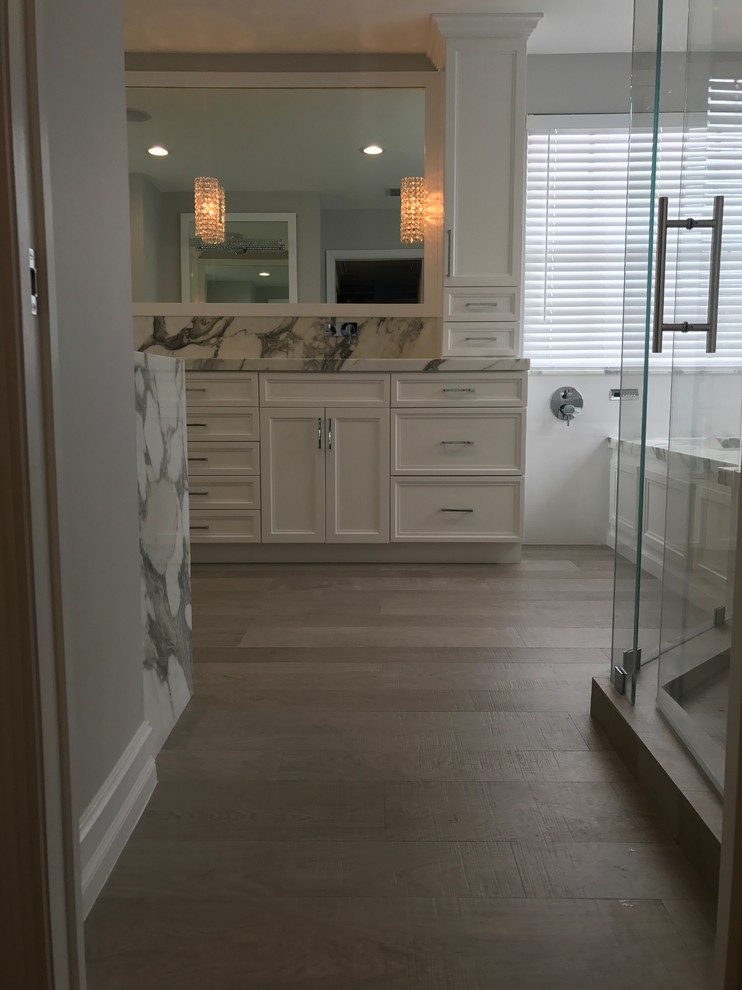 Design ideas for a large transitional master bathroom in Miami with shaker cabinets, white cabinets, an undermount tub, a corner shower, black and white tile, gray tile, marble, grey walls, medium hardwood floors, an undermount sink, marble benchtops, brown floor and a hinged shower door.