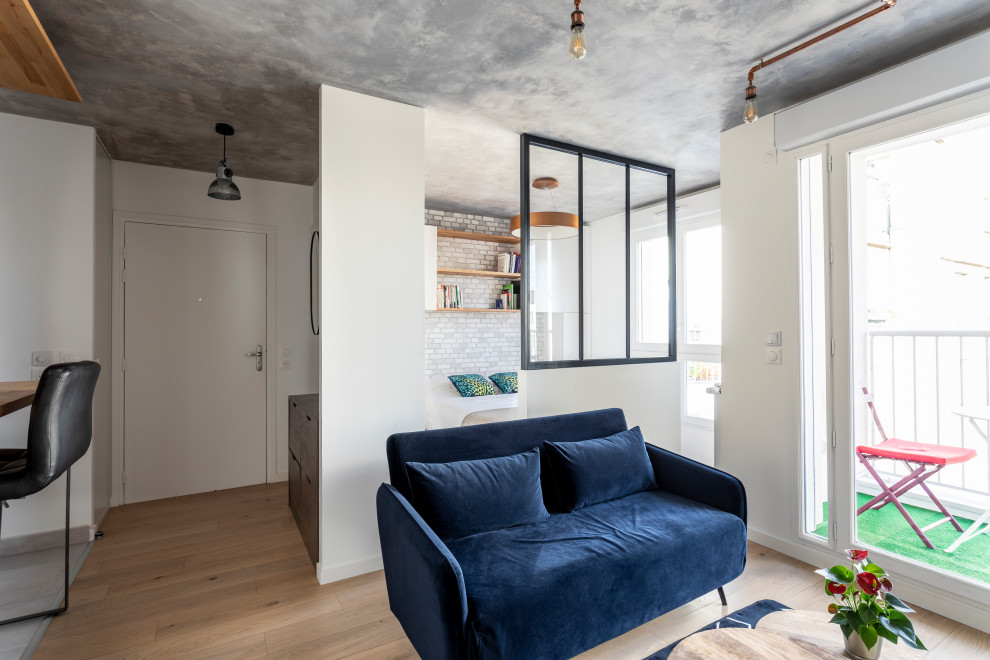 Стильный дизайн: маленькая открытая гостиная комната:: освещение в стиле лофт с серыми стенами, паркетным полом среднего тона, коричневым полом и обоями на стенах для на участке и в саду - последний тренд