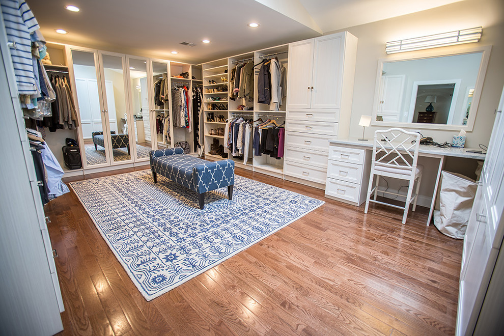 Inspiration for a large transitional gender-neutral walk-in wardrobe in Other with recessed-panel cabinets, white cabinets and medium hardwood floors.