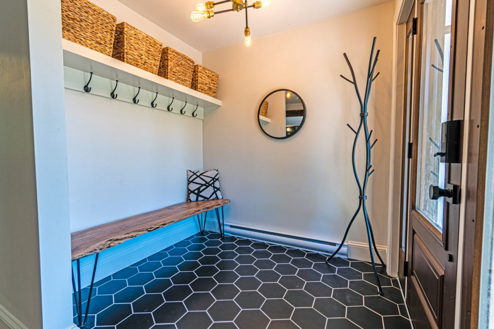 Inspiration for a mid-sized eclectic ceramic tile and black floor foyer remodel with white walls