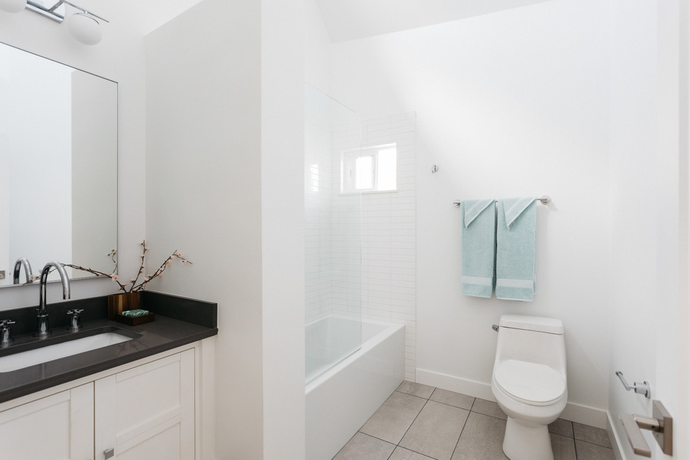 Design ideas for a transitional kids bathroom in Los Angeles with recessed-panel cabinets, white cabinets, a drop-in tub, a shower/bathtub combo, a one-piece toilet, white tile, subway tile, white walls, porcelain floors, an undermount sink, quartzite benchtops, beige floor, an open shower and multi-coloured benchtops.