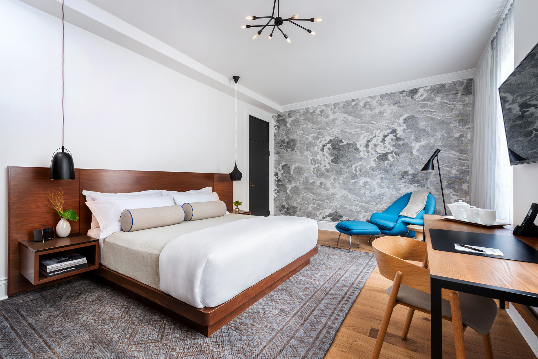 Jill Greaves Design Contemporary Bedroom featuring a custom platform bed in walnut, pendant task lighting and Fornasetti wallpaper mural in "Nuvole".