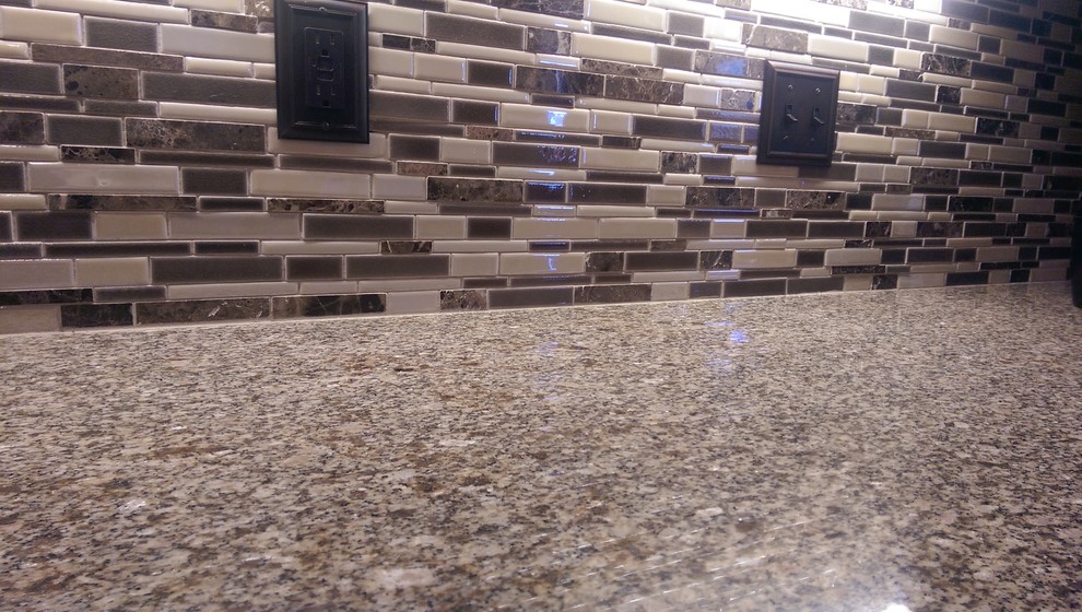 Mid-sized transitional l-shaped laminate floor eat-in kitchen photo with an undermount sink, raised-panel cabinets, white cabinets, granite countertops, multicolored backsplash, mosaic tile backsplash, white appliances and no island