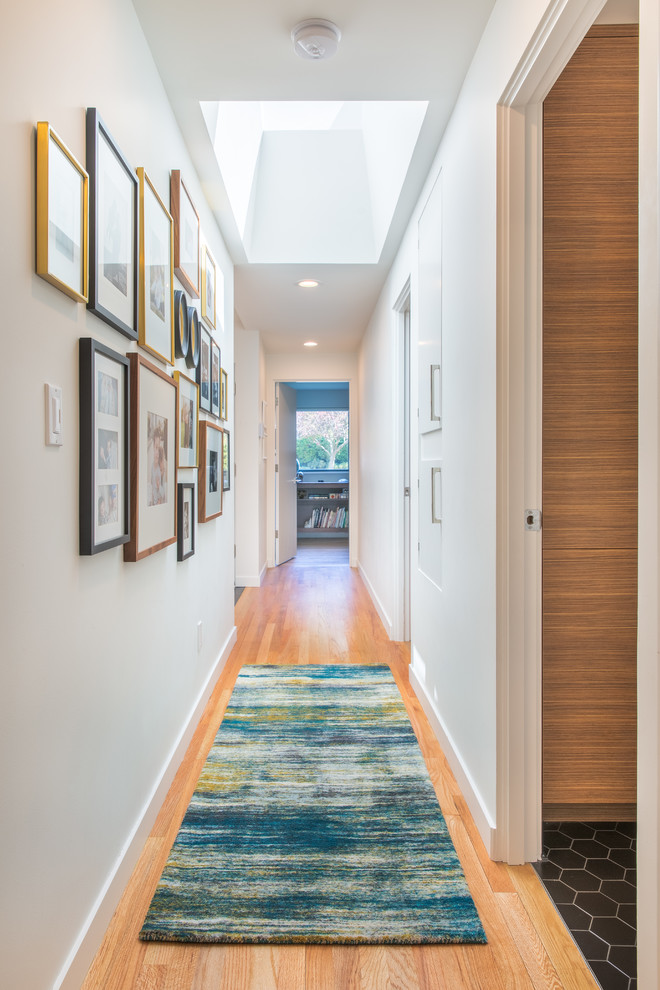 This is an example of a midcentury hallway in Seattle with medium hardwood floors.