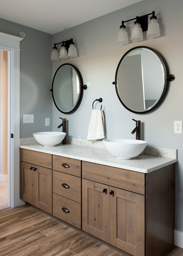Design ideas for a mid-sized traditional 3/4 bathroom in Portland Maine with shaker cabinets, medium wood cabinets, a freestanding tub, gray tile, marble floors, engineered quartz benchtops, grey floor, an open shower, grey benchtops, a double vanity and a built-in vanity.